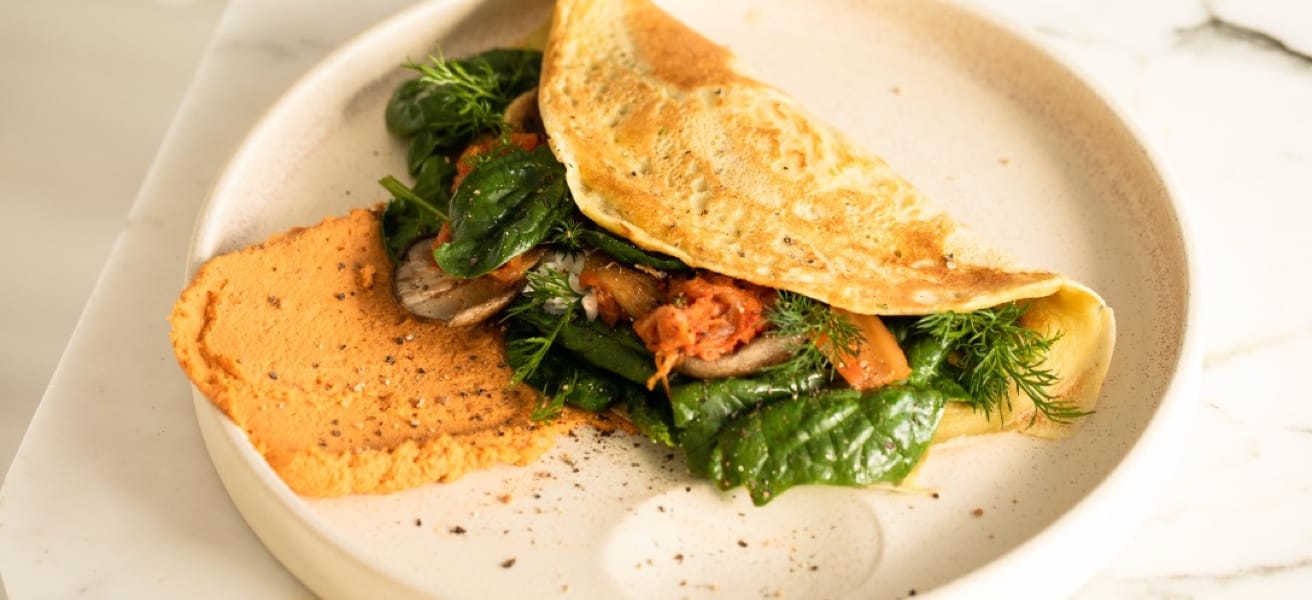 Simple omelette on a plate with greens